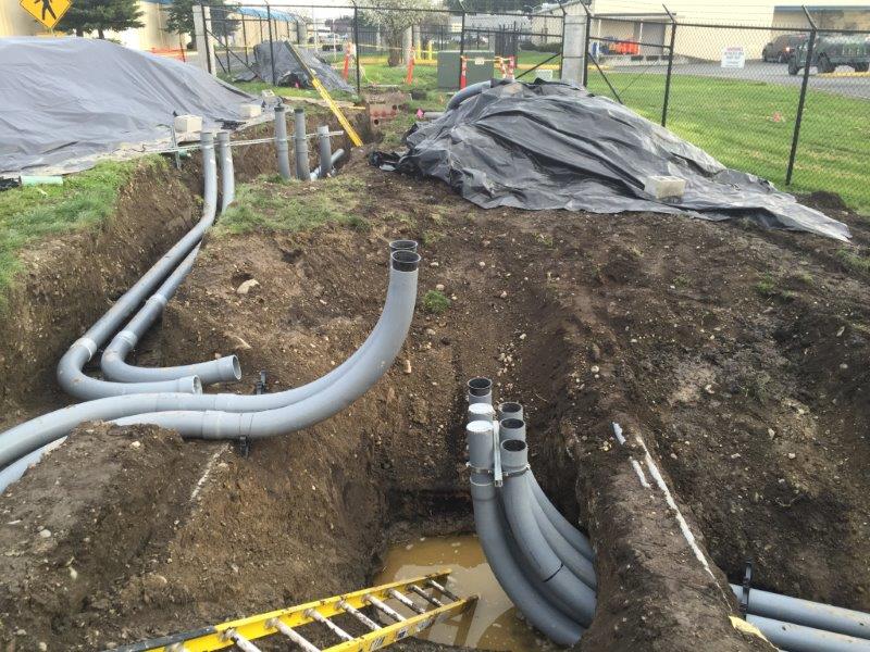 Five inch PVC conduit is installed underground. Upon completion it will contain 12,470 volt conductors to serve two transformers serving the simulator building.